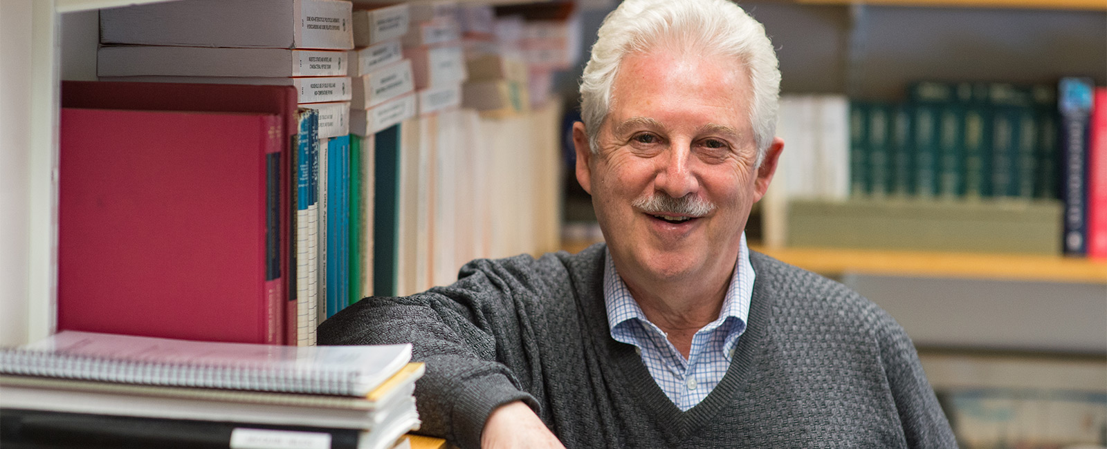 Professor Steven Tannenbaum smiles in his office.