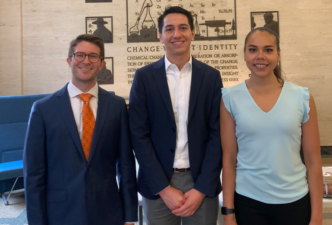 Left to right: Steven Chapman, Antonio Tinoco Valencia, and Melissa Ramirez smile in the lobby of Building 6.