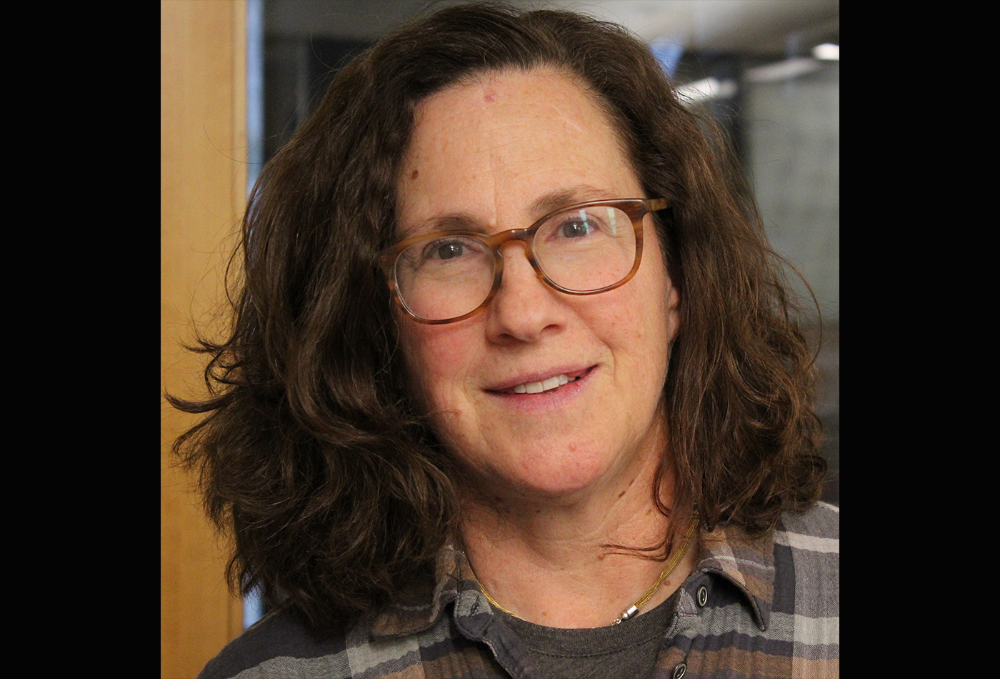 Joanne Baldini smiles in a hallway.